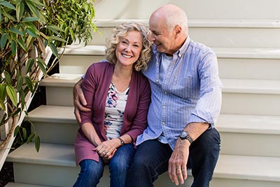 Couple sitting on front doorsteps
